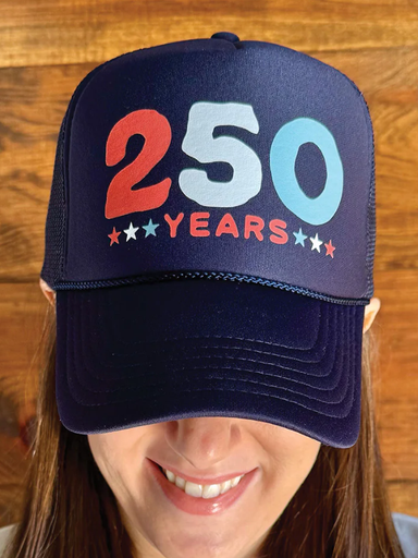 Navy blue cap with '250 Years' text in red and blue on a wooden background