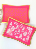 Pink trays with gold edges and white designs 