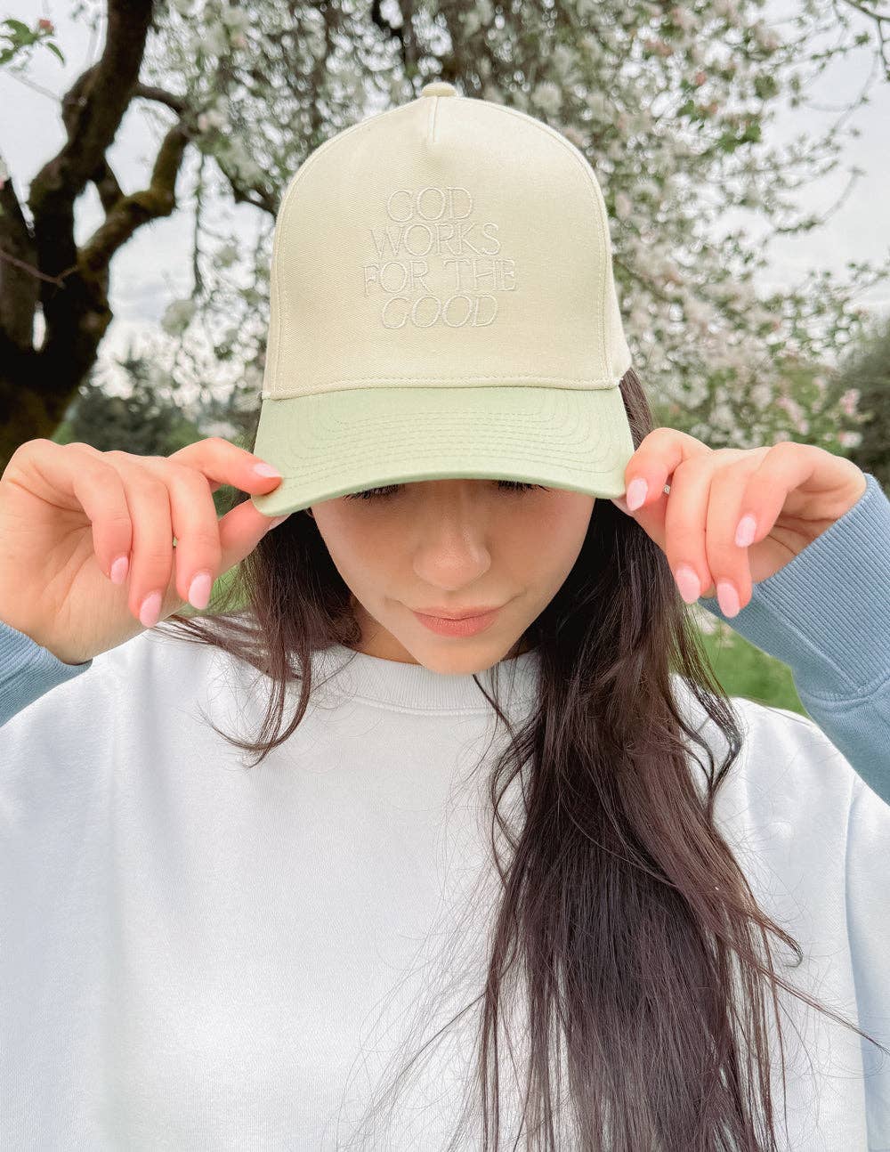 God Works for the Good Trucker Hat