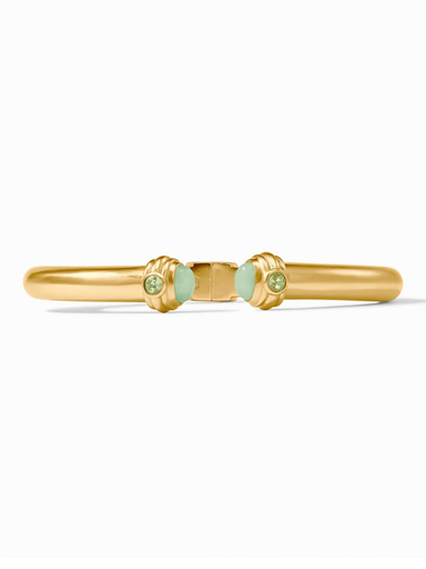 Gold bracelet with green gemstones on a white background