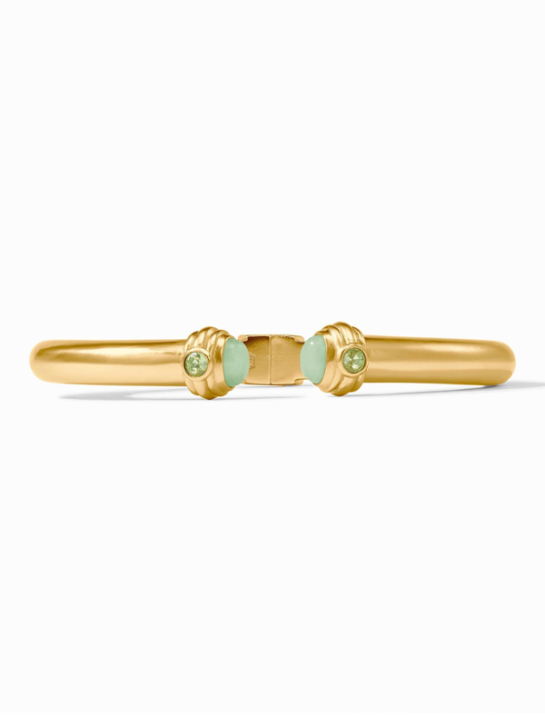 Gold bracelet with green gemstones on a white background