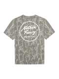 A short-sleeve t-shirt featuring mossy oak camouflage. The back of the shirt is printed with a large white circular logo that reads 'Nuthin Fancy COLLECTION'.