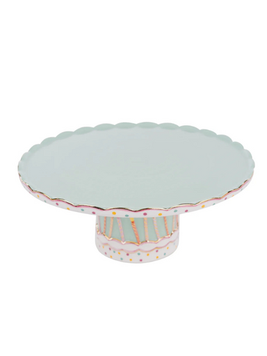 A cake stand with a patterned base and decorative candles around the circumference.