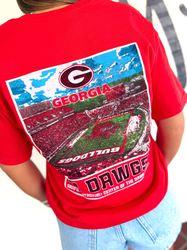 A red t-shirt with a large back graphic featuring the Georgia Bulldogs logo, stadium scene, and 'Dawgs' text