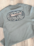 duck call in a camo oval on a green shirt