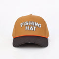 A structured baseball cap with a tan crown, a dark brown curved brim, and an orange accent line. The front of the cap features the words 'FISHING HAT' embroidered in white 