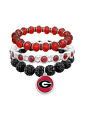 Three stacked beaded stretch bracelets in red, white, and black, featuring a Georgia Bulldogs logo charm at the bottom.