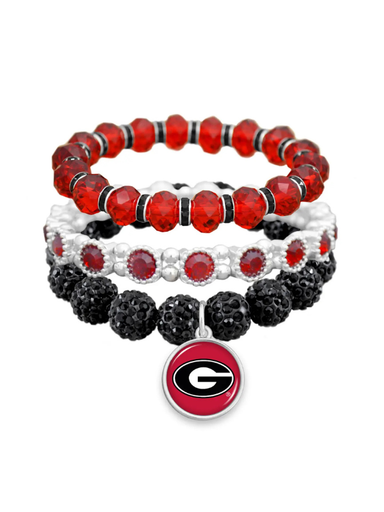 Three stacked beaded stretch bracelets in red, white, and black, featuring a Georgia Bulldogs logo charm at the bottom.