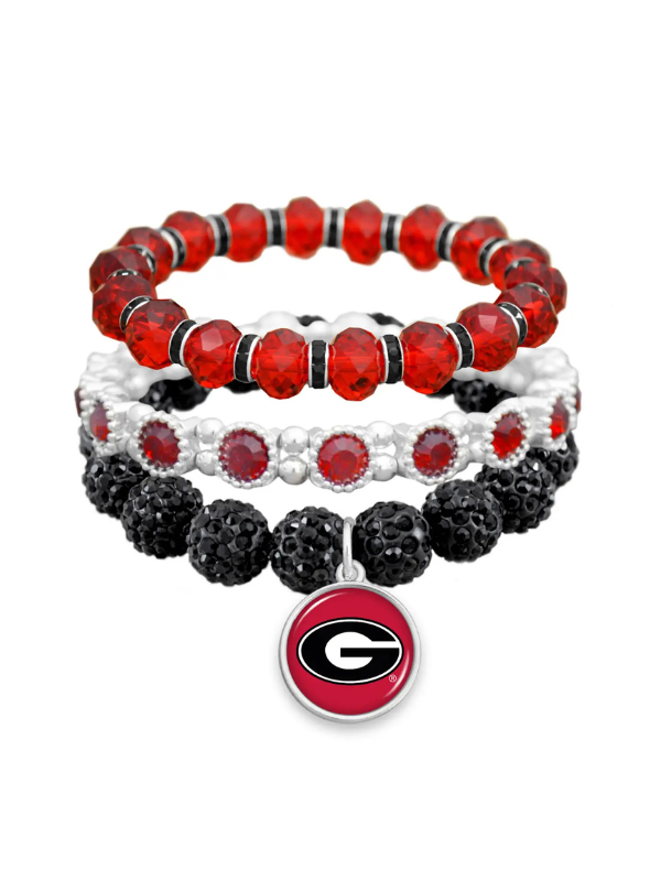Three stacked beaded stretch bracelets in red, white, and black, featuring a Georgia Bulldogs logo charm at the bottom.