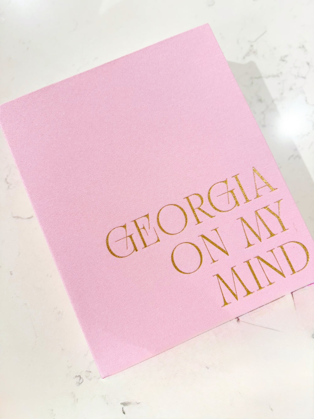 A pink hollow keepsake box with Georgia On My Mind on it