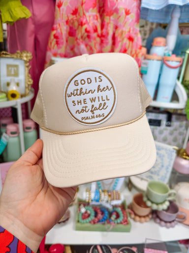 Tan trucker hat with embroidered patch reading “God Is Within Her She Will Not Fail Psalm 46:5”.