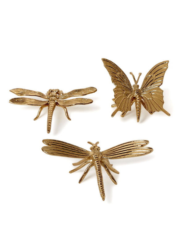 Three gold insect-themed decor pieces, including two dragonflies and one butterfly.