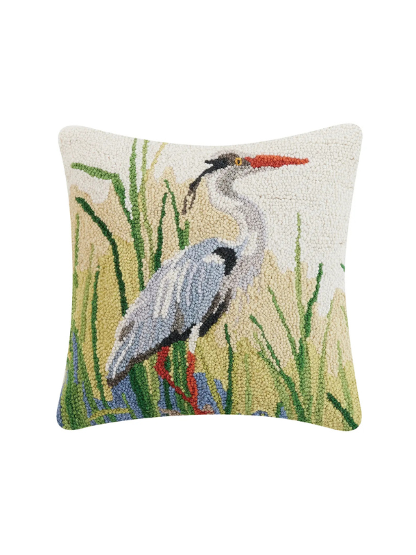Decorative pillow with a heron design on a white background