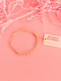 A gold-filled fluted beaded bracelet with elastic string