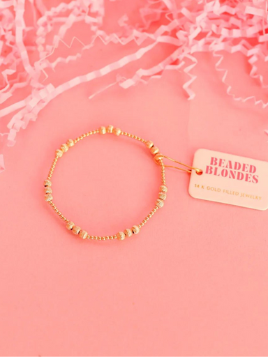 A gold-filled fluted beaded bracelet with elastic string