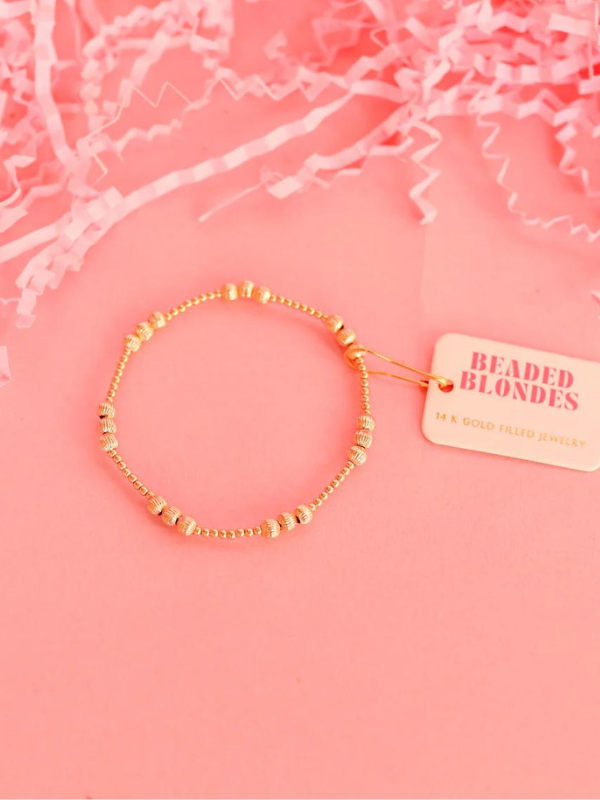 A gold-filled fluted beaded bracelet with elastic string