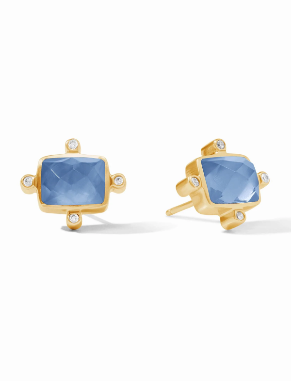 Gold earrings with blue gemstones on a white background