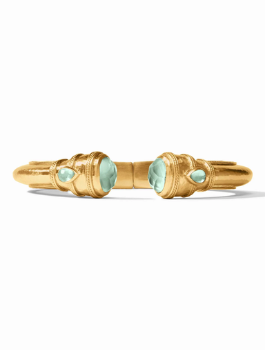 Gold bracelet with green gemstones on a white background