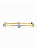 Gold bracelet with blue stones on a white background