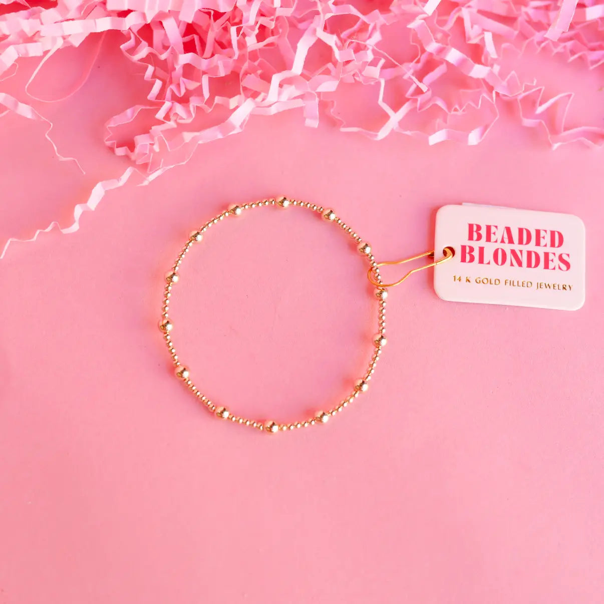 A gold-filled bracelet with a mix of smaller and larger beads
