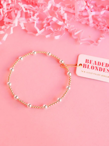 A gold-filled gold and silver beaded bracelet with elastic string