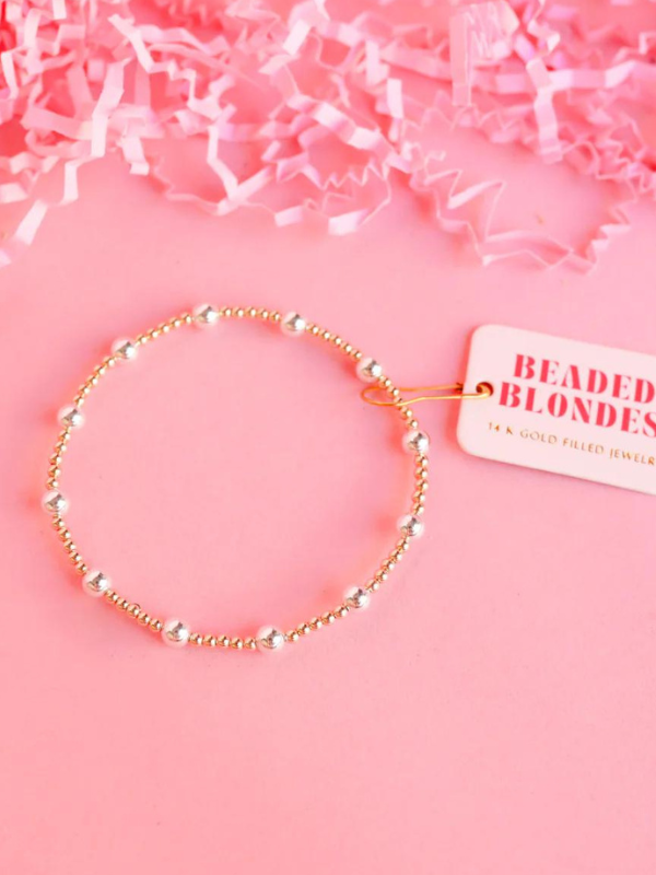 A gold-filled gold and silver beaded bracelet with elastic string