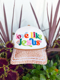White trucker hat with colorful embroidered “Love Like Jesus” lettering, spotted tan brim, John 13:34 side embroidery, and colorful faith-inspired embroidered icons on the back.
