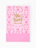 Pink notebook with floral pattern and 'Make today amazing' text on a white background