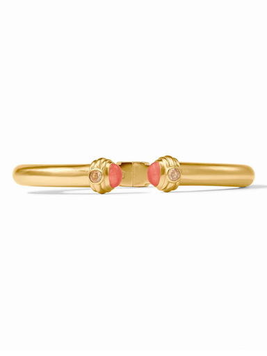 Gold ring with pink stones on a white background