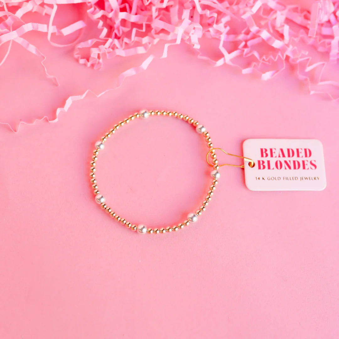 A gold-filled beaded bracelet with silver accents.