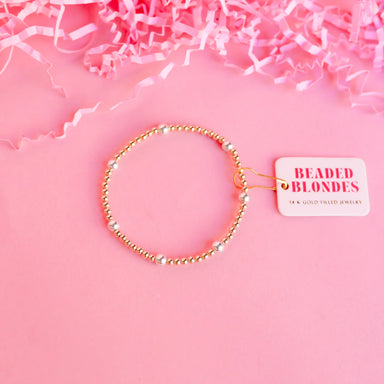 A gold-filled beaded bracelet with silver accents.