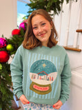 teal sweatshirt with a snow globe on the front with baby jesus 