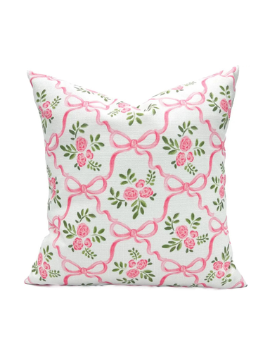 Decorative pillow with pink bows and flowers