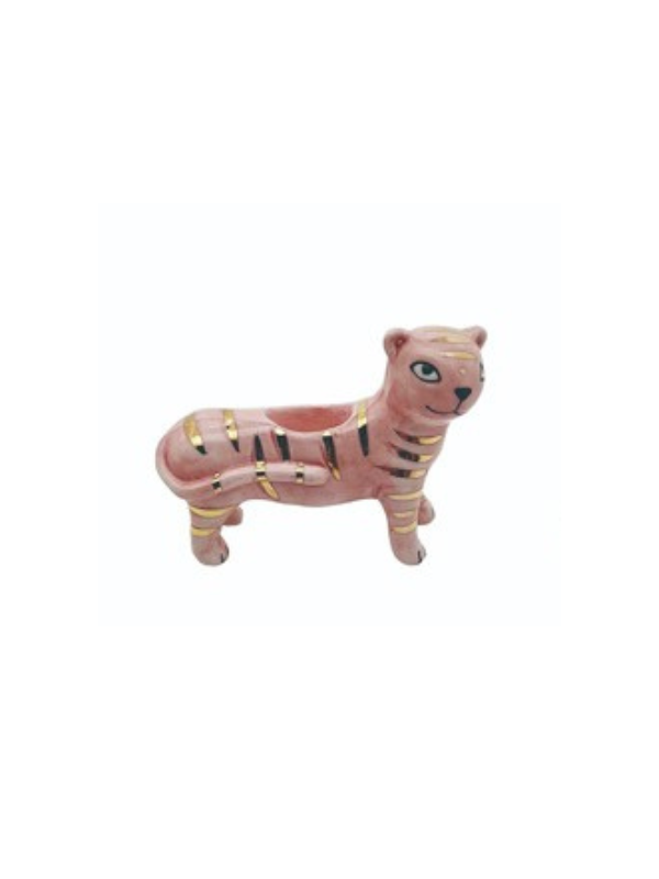 A pink ceramic match holder in the shape of a tiger with gold stripes 