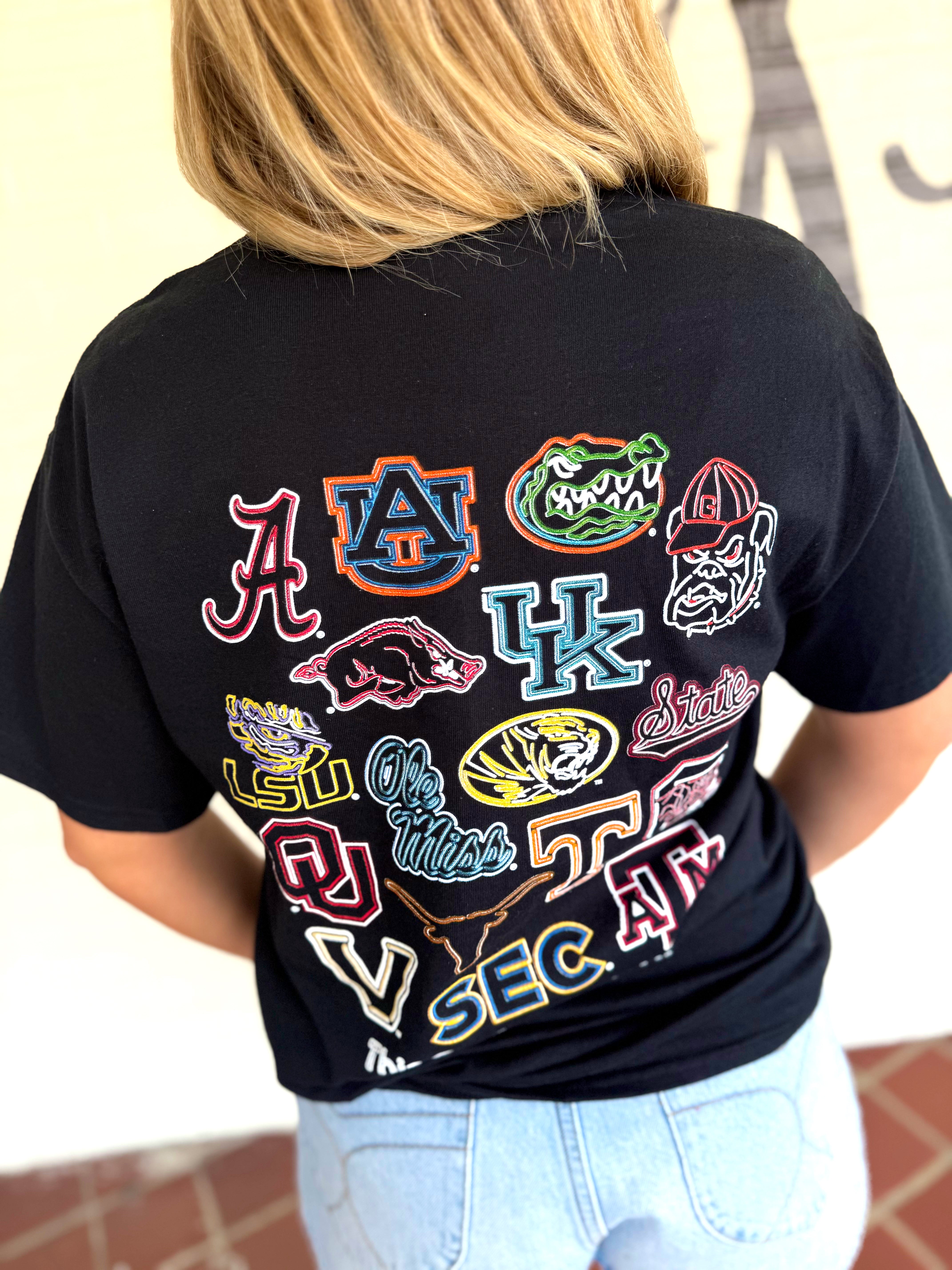 A black graphic T-shirt with multiple colorful athletic logos in the SEC