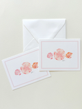 Two stationery items with shell designs on a light background