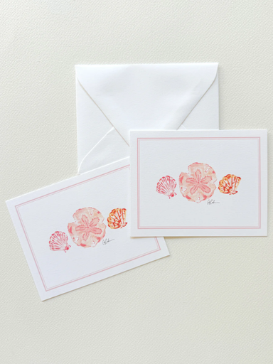 Two stationery items with shell designs on a light background
