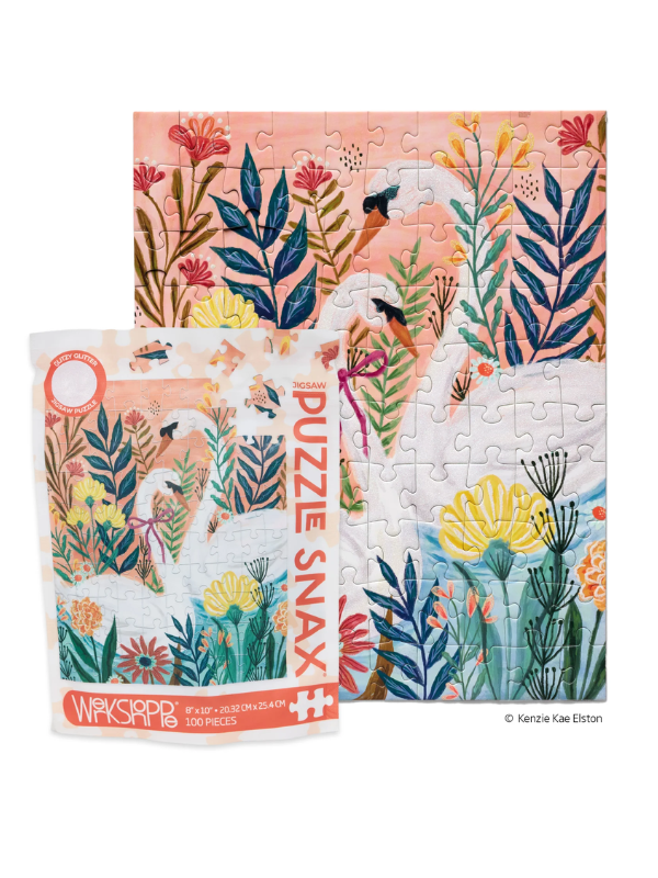 A jigsaw puzzle and its packaging shown on a white background. The puzzle features a colorful botanical design with pink, blue, yellow, and green floral elements, and the package reads 'PUZZLE SNAX' and 'WIKISAPP'.