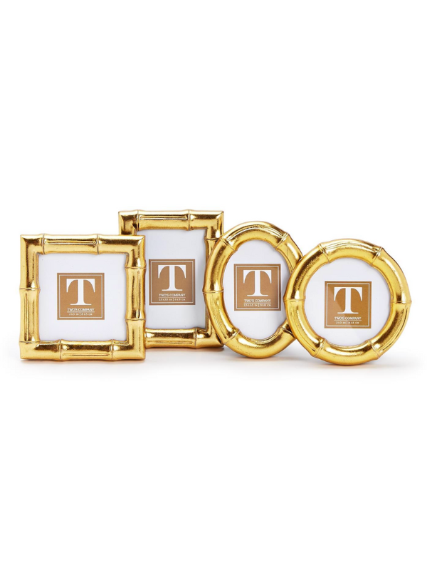 Set of gold photo frames with a central round frame and two square frames on a white background.