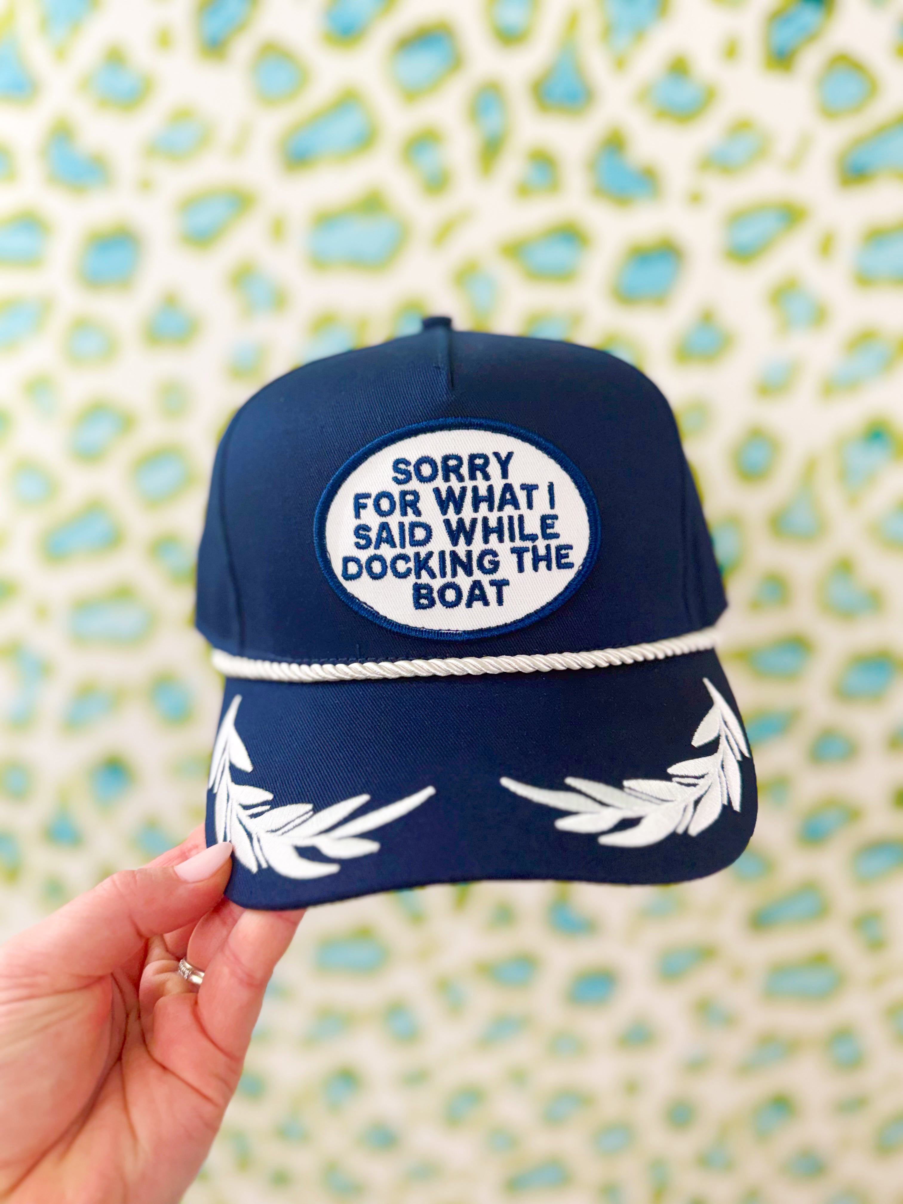 Navy blue rope cap with white text and patch design 