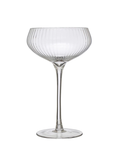 Clear glass cocktail glass with ribbed design on a white background