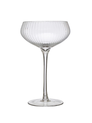 Clear glass cocktail glass with ribbed design on a white background