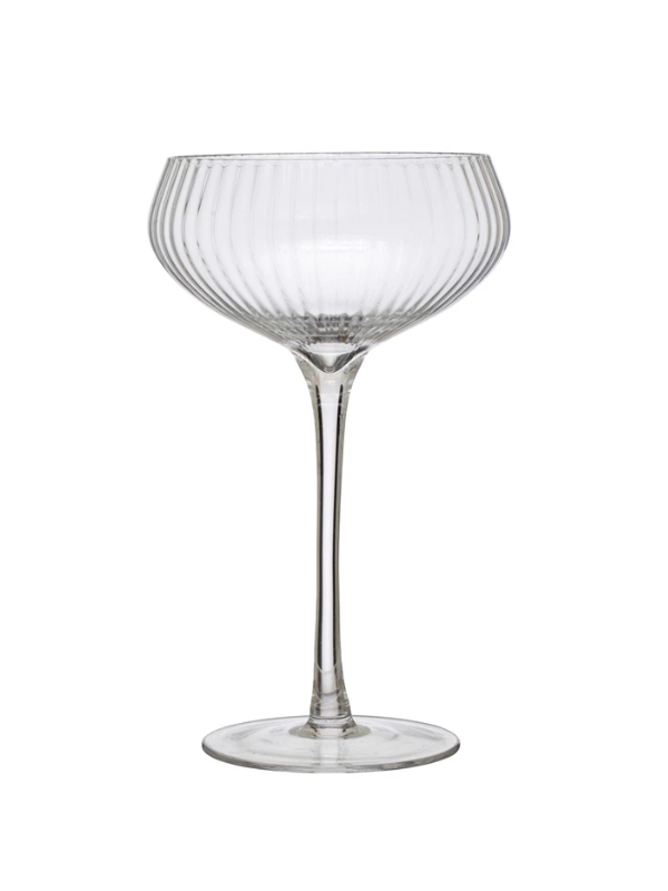 Clear glass cocktail glass with ribbed design on a white background