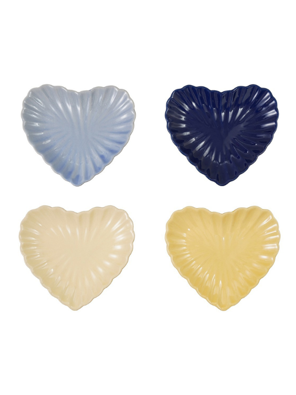 Four heart-shaped scallop-edged plates arranged featuring light blue, dark navy, cream, and pale yellow colors.