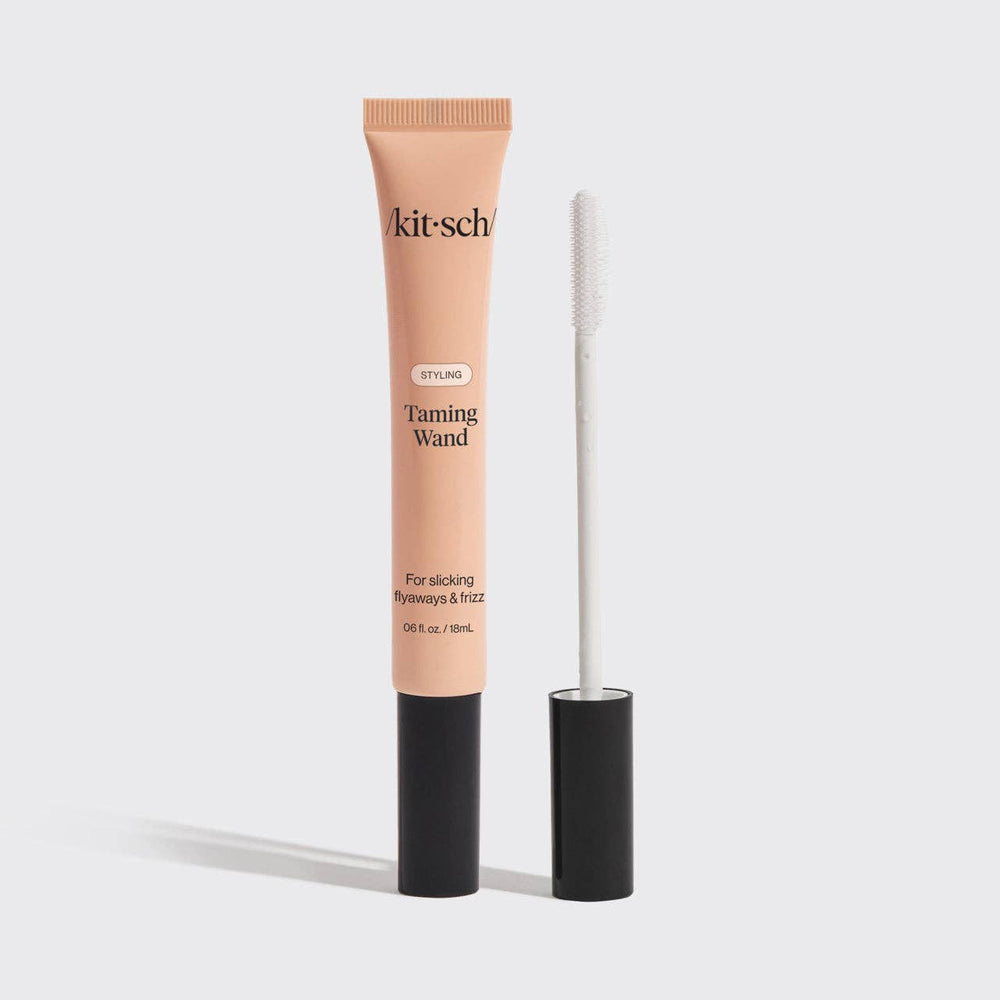 A tube of kitsch Styling Taming Wand with an applicator wand, designed for smoothing strands and taming frizz.