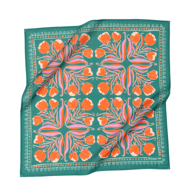 A teal bandana with orange and pink floral patterns, laid flat.