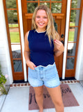 A sleeveless navy blue ribbed knit top with a white crew neck trim.