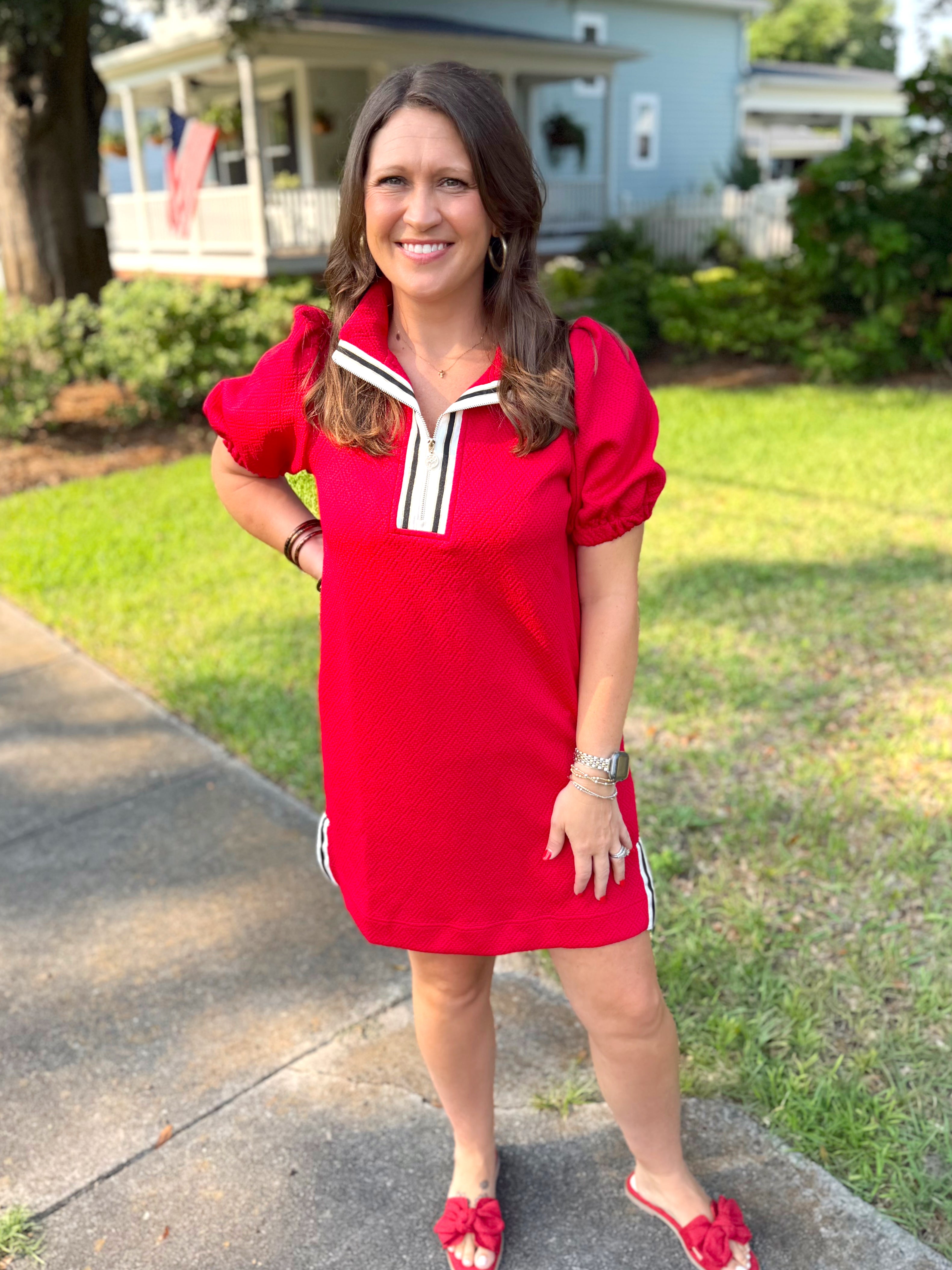 A red short-sleeve puff-sleeve dress with a white and black sailor-style collar, by Mary Square