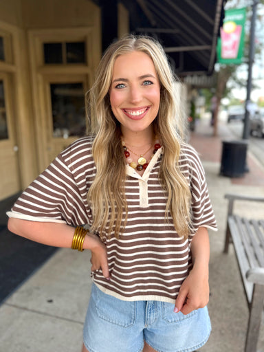 A brown and cream horizontally striped short-sleeve light sweater.