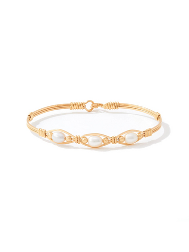 Gold bracelet with pearls on a white background